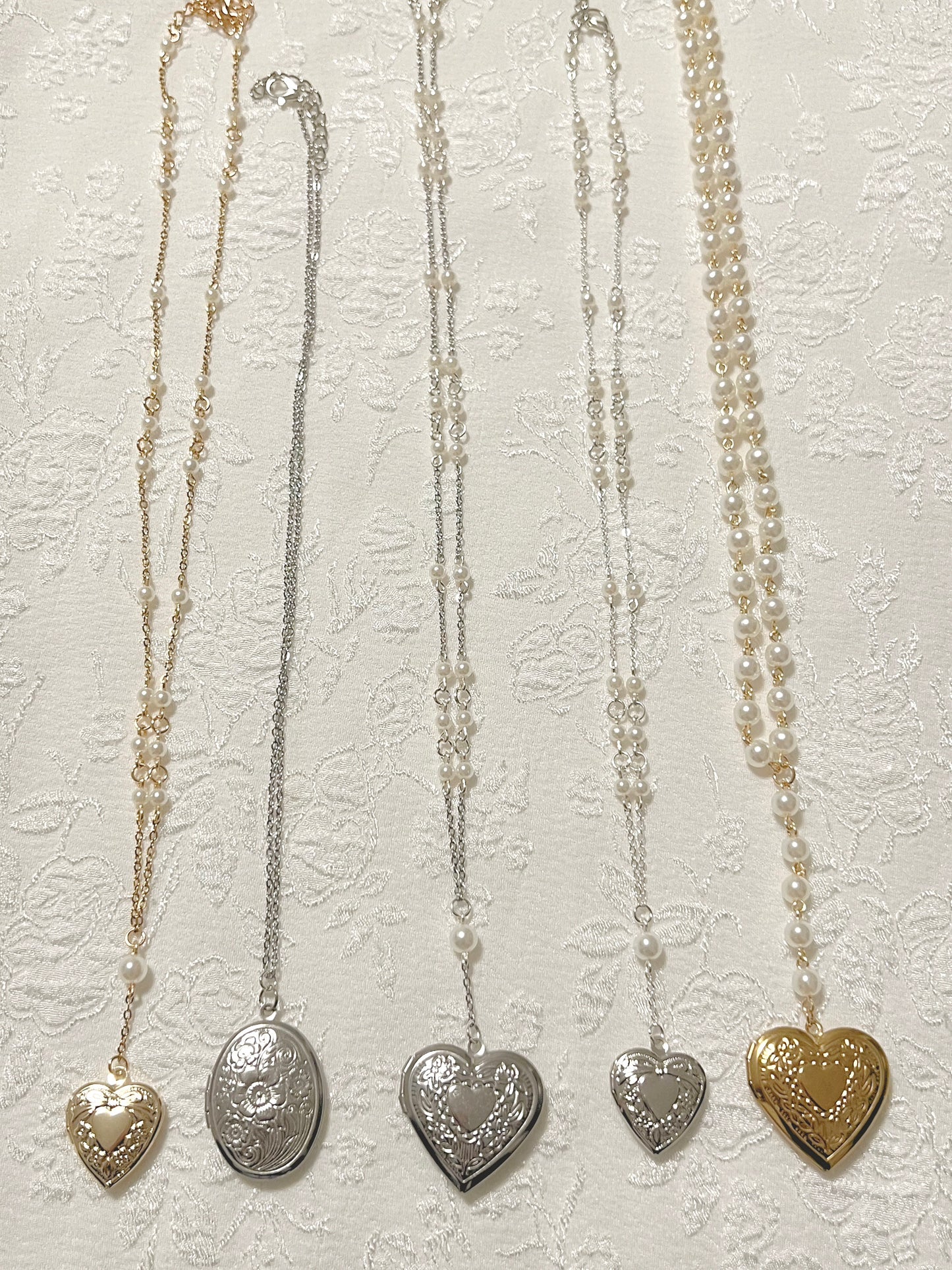 Gold and silver mixed collection of coquette chain and pearl locket necklaces, heart shaped, over shaped, small and large