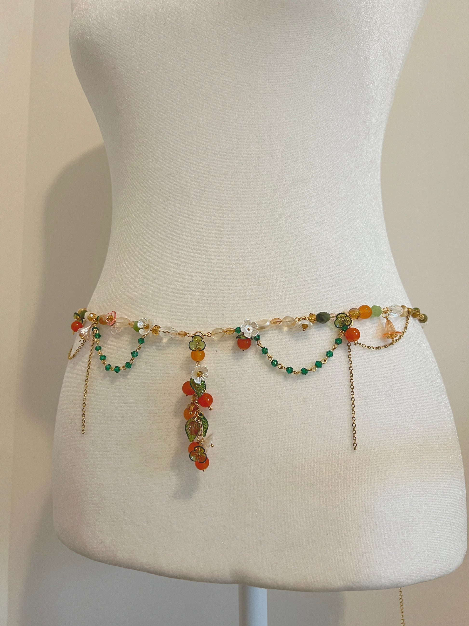 Handmade floral waist bead with orange, green beads and gold chains, perfect for boho style.