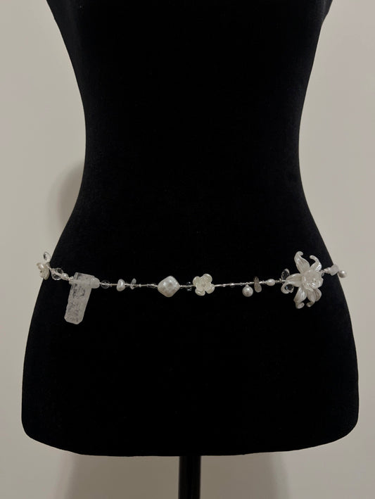 Elegant handmade waist bead with pearls and floral accents, perfect for accessorizing any outfit.